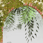 Load image into Gallery viewer, Close-up detail showing hanging fern fronds, white blossom vine and weathered brickwork on the arch