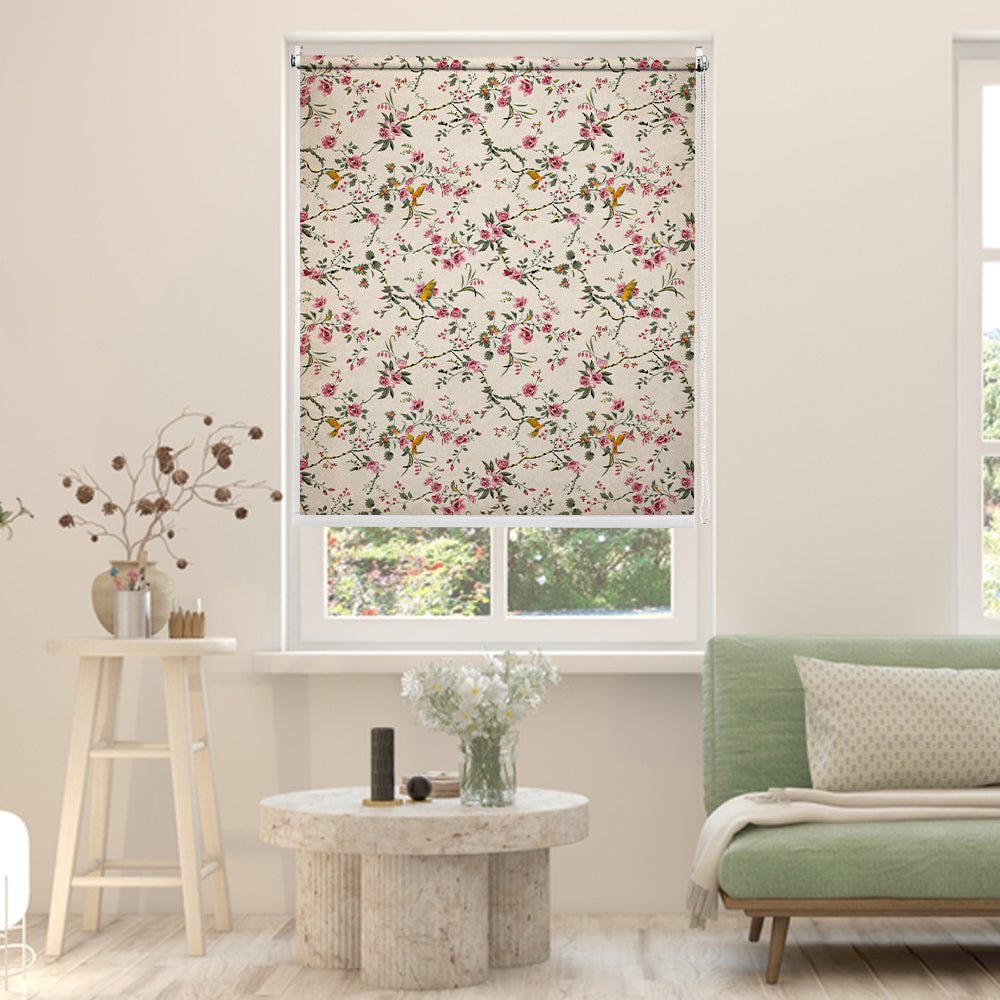 Tropical blackout window blind with blue and gold macaws flying among pink blossom branches on an antique ivory ground - Lolli & Omi
